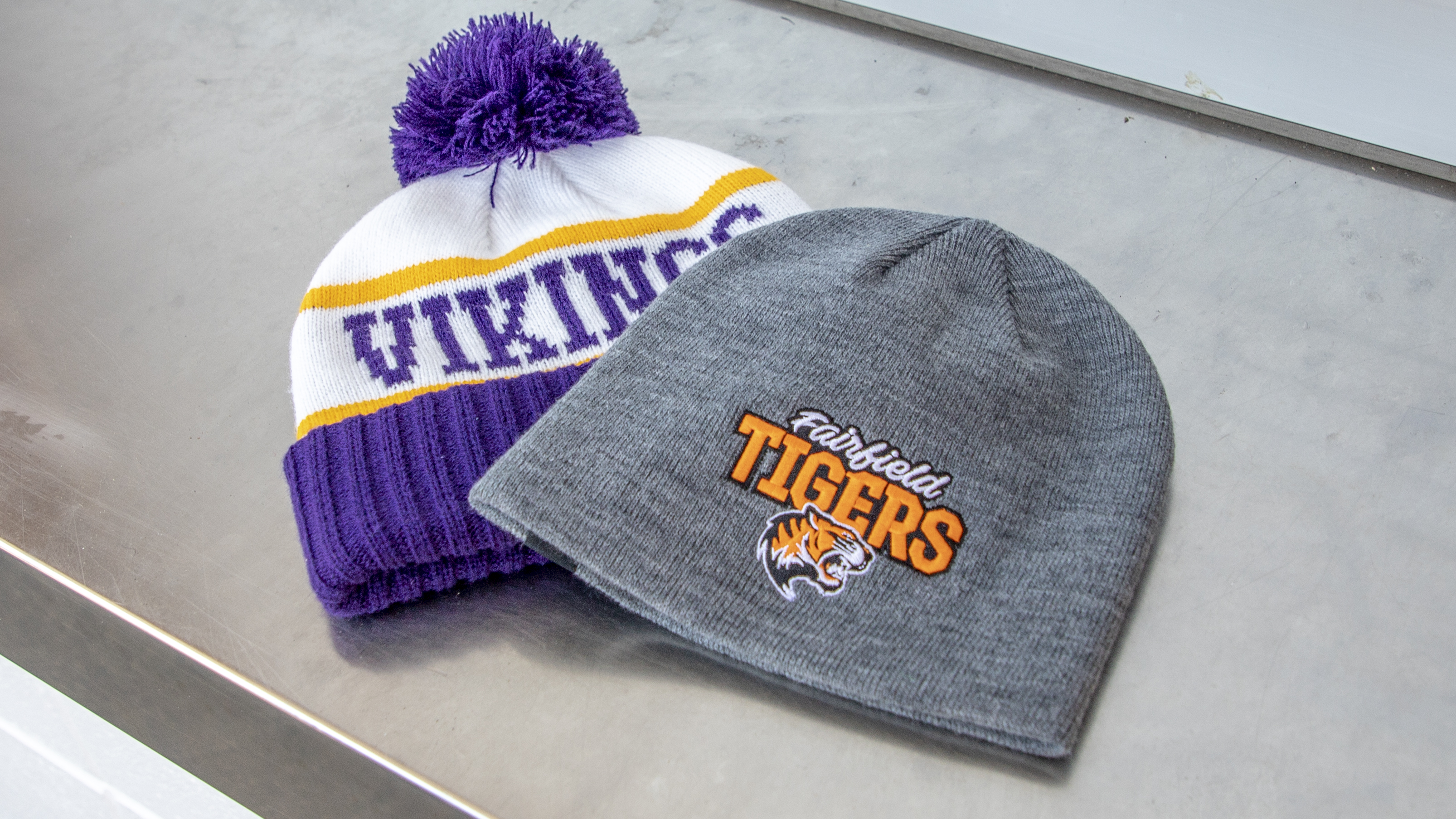 Cold Weather knit hats laying on bleacher seat