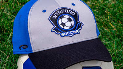 A Soccer hat on top of a soccer ball