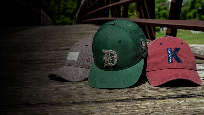 Three Pukka hats sitting on a wood bench