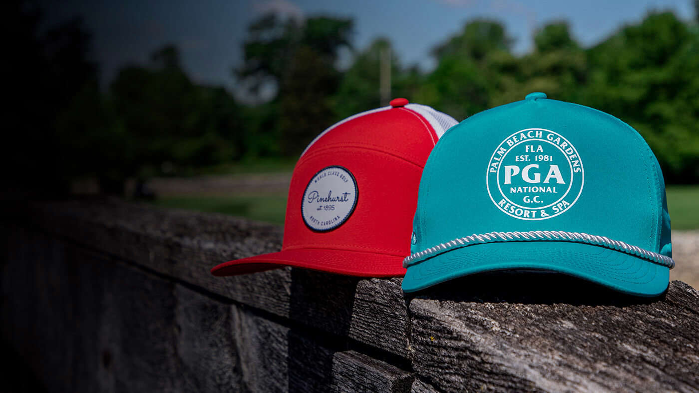 Three Tour hats resting by a pond