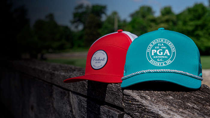 Three Tour hats resting by a pond