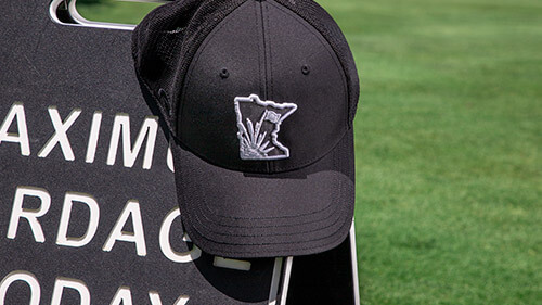 Golf Ultra-Fit hat sitting on a rock