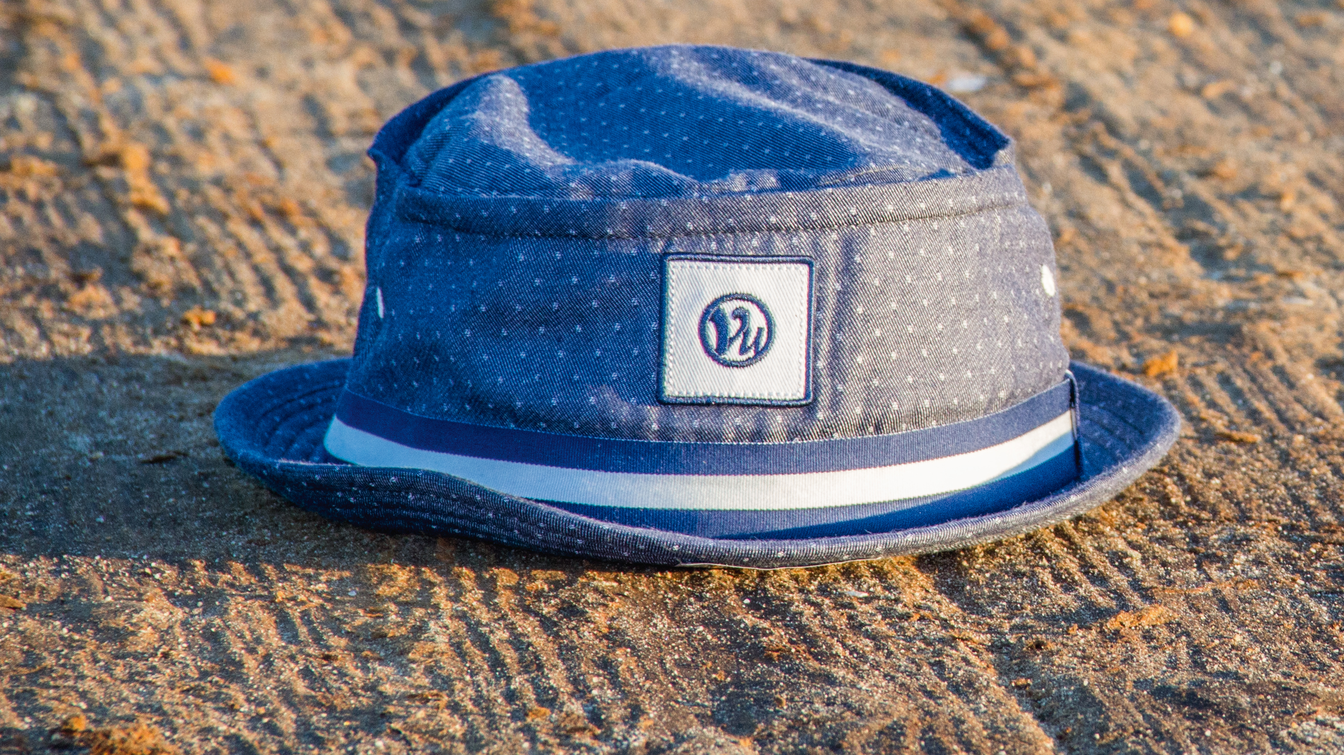 Reilley bucket hat sitting on sand